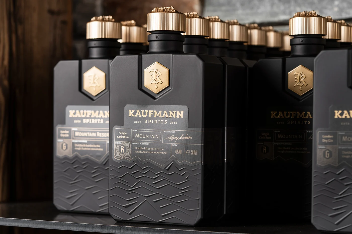 Kaufmann Spirits bottles with golden caps at the bar